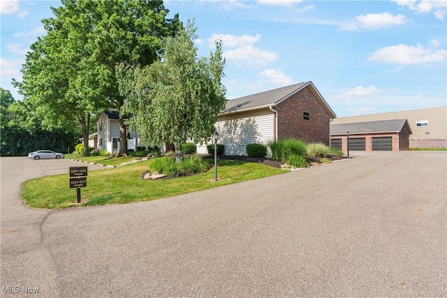 1234 W Maple St, North Canton, OH 44720 - view of front of house with brick siding and a front lawn