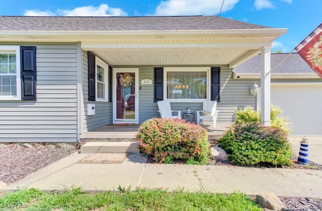 201 Noble St W, East Canton, OH 44730 - entrance to property with a porch, an attached garage, and a shingled roof