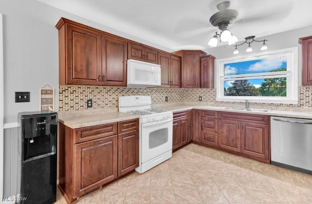 201 Noble St W, East Canton, OH 44730 - kitchen with white appliances, tasteful backsplash, ceiling fan, and light countertops