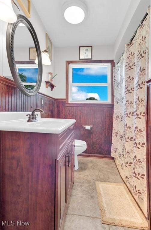 201 Noble St W, East Canton, OH 44730 - full bath featuring vanity, a wainscoted wall, wooden walls, and curtained shower