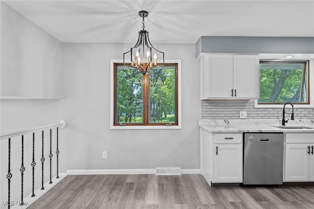 1303 E Dartmoor Ave, Seven Hills, OH 44131 - kitchen featuring stainless steel dishwasher, wood finished floors, and plenty of natural light