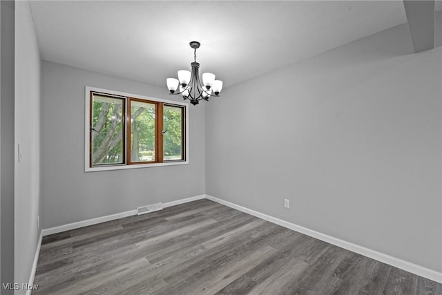 1303 E Dartmoor Ave, Seven Hills, OH 44131 - unfurnished room with a chandelier and wood finished floors
