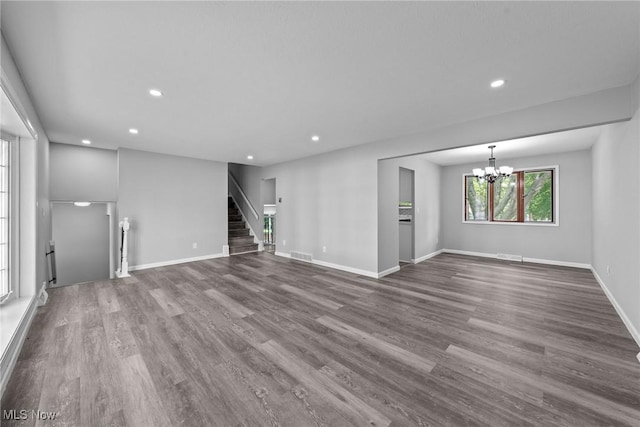 1303 E Dartmoor Ave, Seven Hills, OH 44131 - unfurnished living room with recessed lighting, dark wood-style floors, stairs, and a chandelier