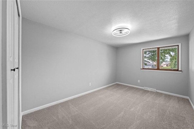 1303 E Dartmoor Ave, Seven Hills, OH 44131 - carpeted empty room with a textured ceiling and baseboards