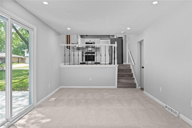 1303 E Dartmoor Ave, Seven Hills, OH 44131 - unfurnished living room with carpet flooring and recessed lighting
