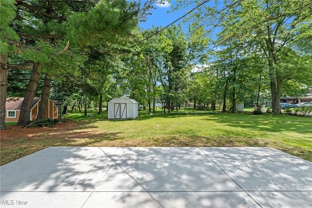 1303 E Dartmoor Ave, Seven Hills, OH 44131 - view of green lawn with a shed and a patio