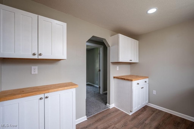 1320 21st St, Vienna, WV 26105 - kitchen featuring butcher block counters, arched walkways, dark wood-style floors, white cabinets, and a textured ceiling