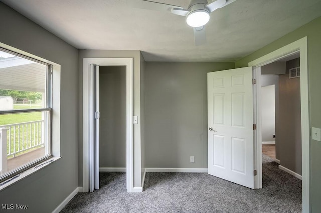 1320 21st St, Vienna, WV 26105 - unfurnished bedroom featuring multiple windows, carpet floors, and a ceiling fan
