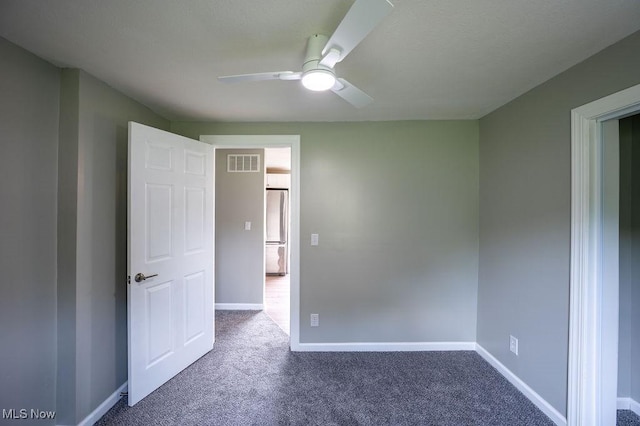 1320 21st St, Vienna, WV 26105 - unfurnished bedroom featuring carpet, freestanding refrigerator, and ceiling fan