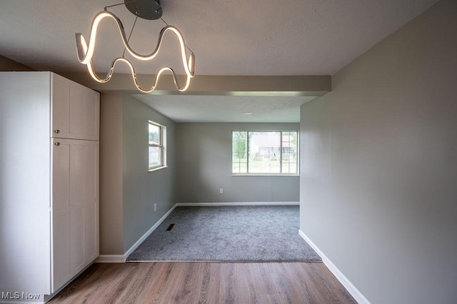 1320 21st St, Vienna, WV 26105 - spare room with a textured ceiling and wood finished floors
