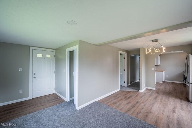 1320 21st St, Vienna, WV 26105 - unfurnished living room featuring wood finished floors and a chandelier