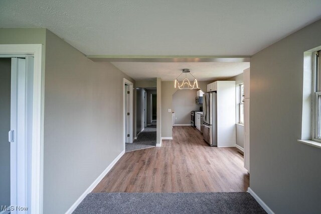 1320 21st St, Vienna, WV 26105 - hallway with a chandelier and light wood finished floors
