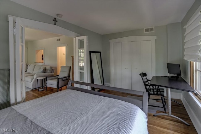 2472 Overlook Rd Unit 5, Cleveland Heights, OH 44106 - bedroom featuring wood finished floors, a closet, and multiple windows