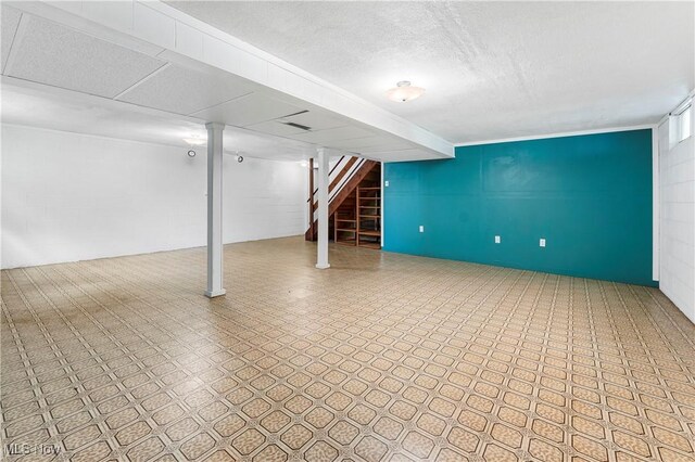 9852 Hocking St NW, Massillon, OH 44646 - finished basement featuring tile patterned floors, stairs, and a textured ceiling