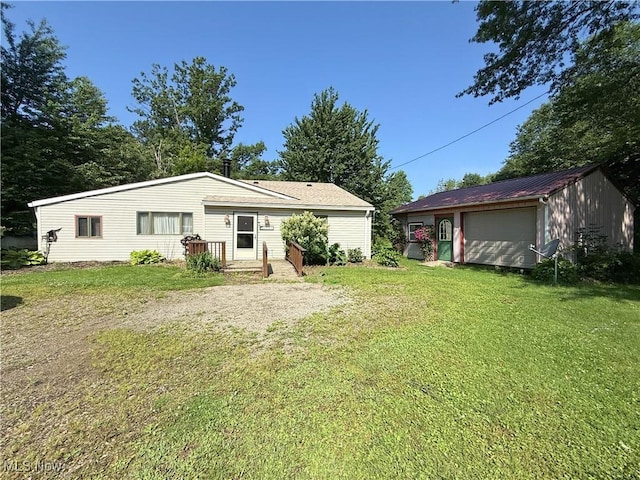 8756 Cook Rd, Salem, OH 44460 - rear view of house featuring an outbuilding, a lawn, and a detached garage