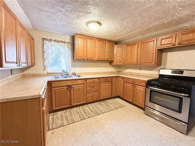 8756 Cook Rd, Salem, OH 44460 - kitchen featuring stainless steel range with gas stovetop, light countertops, a textured ceiling, and brown cabinetry