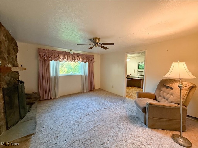 8756 Cook Rd, Salem, OH 44460 - carpeted living room with a ceiling fan, a textured ceiling, and a stone fireplace