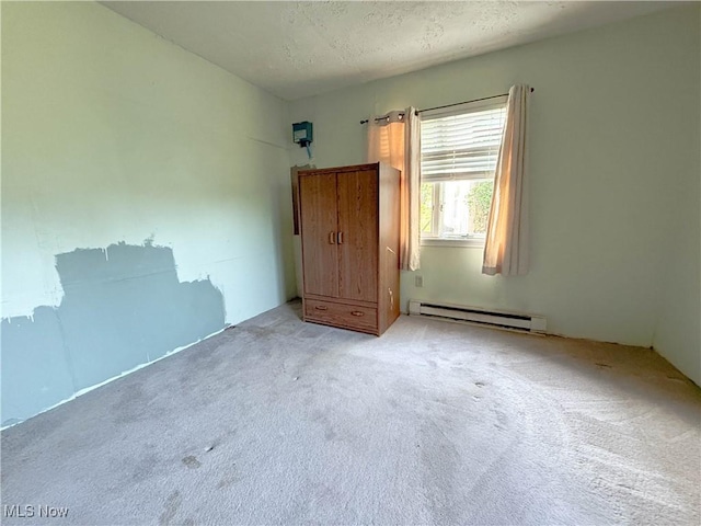 8756 Cook Rd, Salem, OH 44460 - unfurnished bedroom featuring a baseboard heating unit, carpet flooring, and a textured ceiling
