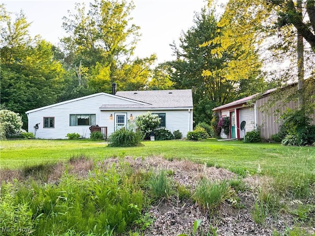 8756 Cook Rd, Salem, OH 44460 - view of front of home featuring a front lawn, a detached garage, and an outbuilding