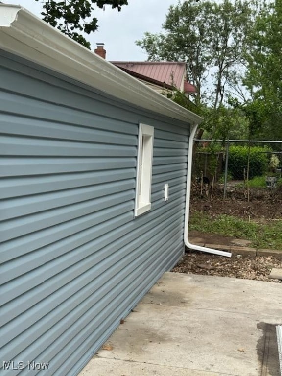 1146 Easton Dr, Akron, OH 44310 - view of side of property featuring a patio area and a chimney
