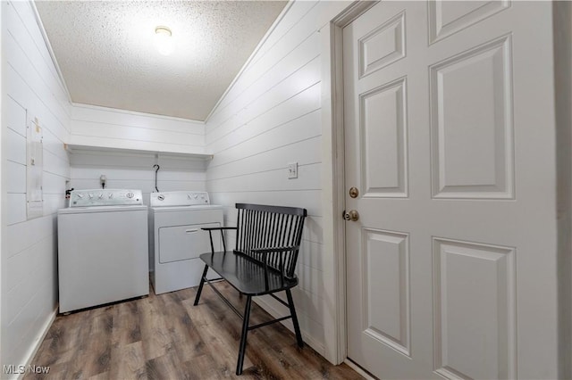 2176 Pageant Rd SE, Carrollton, OH 44615 - laundry room featuring independent washer and dryer, a textured ceiling, wood finished floors, and wooden walls