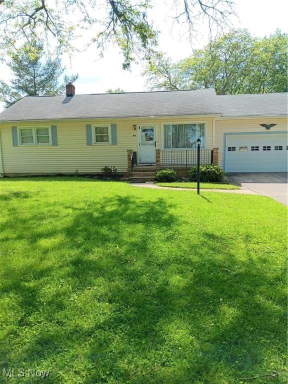 458 W 130th St, Brunswick, OH 44212 - single story home with a garage, concrete driveway, a front lawn, and a chimney