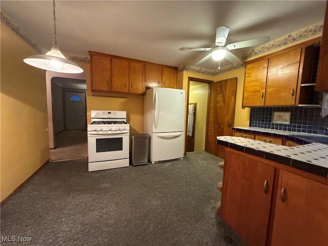 kitchen featuring white appliances, tile countertops, brown cabinetry, and dark carpet