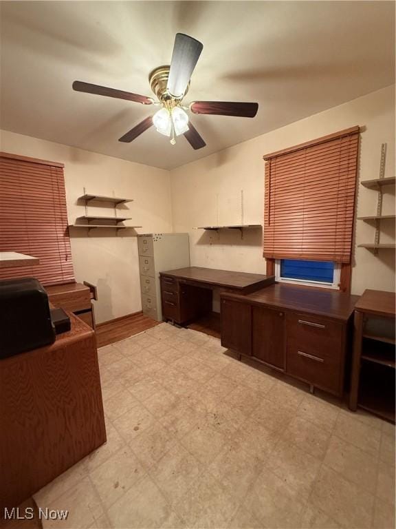 unfurnished office featuring ceiling fan and light flooring