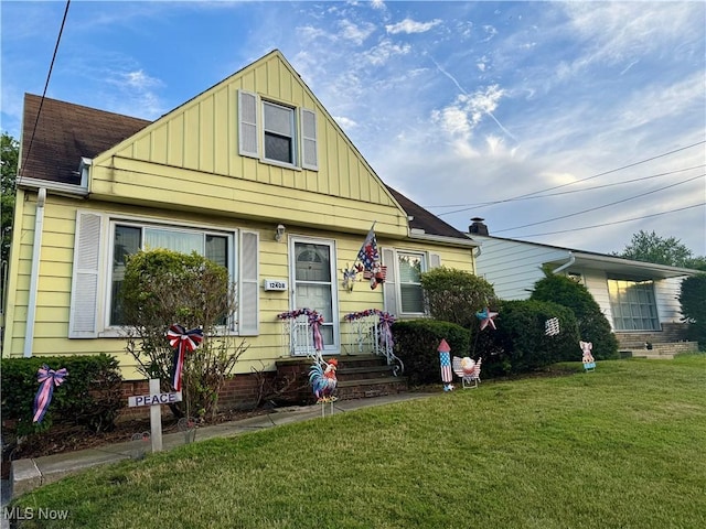 view of front of home with board and batten siding and a front yard