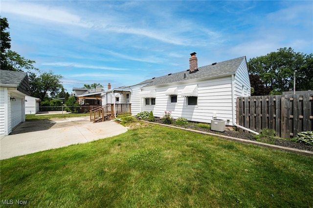 5132 Chestnut Hill Dr, Willoughby, OH 44094 - back of property with a chimney, a garage, a shingled roof, and a patio area