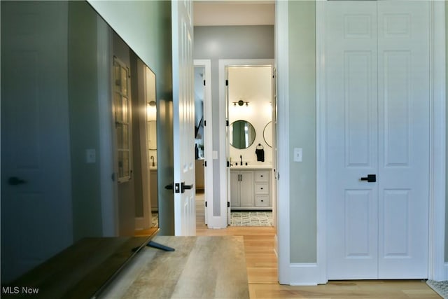 257 Country Club Dr SE, Warren, OH 44484 - hall with light wood finished floors and a sink