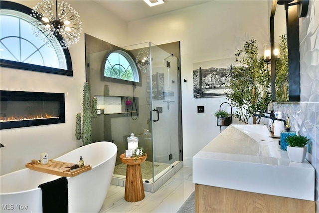 257 Country Club Dr SE, Warren, OH 44484 - full bath featuring a stall shower, a chandelier, a freestanding bath, and vanity