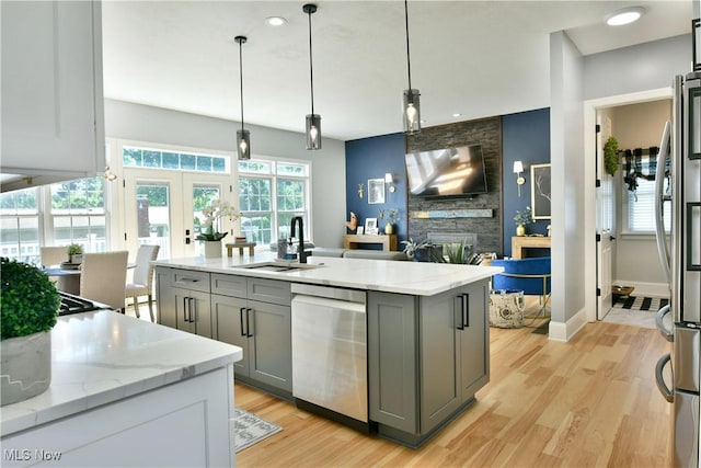 257 Country Club Dr SE, Warren, OH 44484 - kitchen featuring stainless steel appliances, gray cabinetry, light wood finished floors, light stone countertops, and french doors