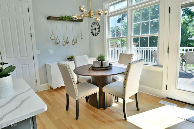 257 Country Club Dr SE, Warren, OH 44484 - dining area featuring light wood-type flooring and a chandelier