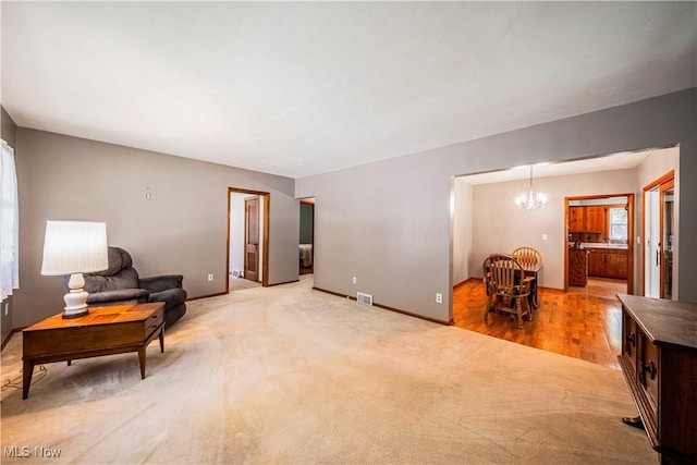 3988 Lake Rd, Conneaut, OH 44030 - living area featuring a chandelier and light carpet