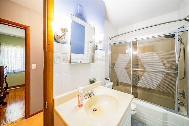 3988 Lake Rd, Conneaut, OH 44030 - bathroom featuring tile walls, enclosed tub / shower combo, and vanity