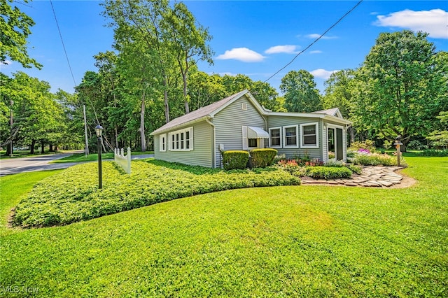 3988 Lake Rd, Conneaut, OH 44030 - view of property exterior featuring a yard
