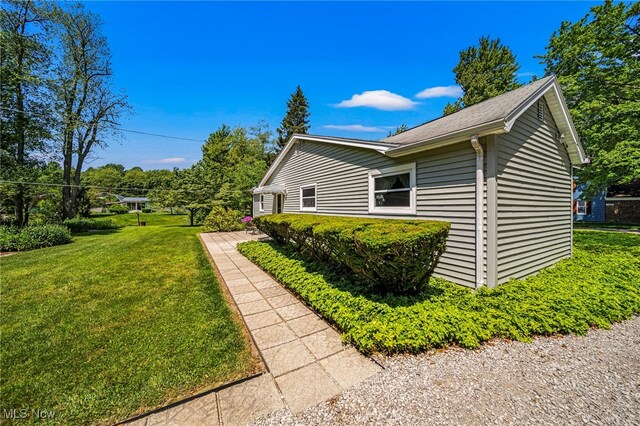 3988 Lake Rd, Conneaut, OH 44030 - view of home's exterior with a yard