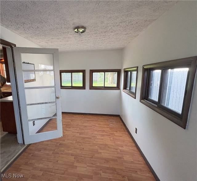 9513 Edison St NE, Alliance, OH 44601 - spare room featuring a textured ceiling and light wood-type flooring