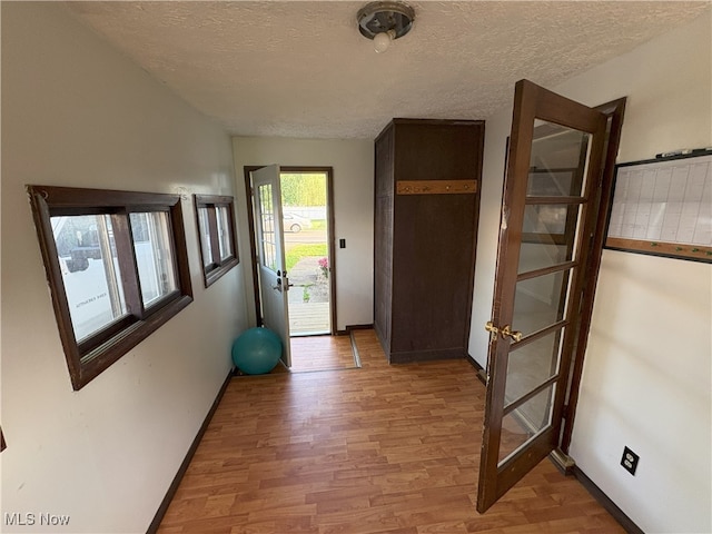 9513 Edison St NE, Alliance, OH 44601 - entryway featuring light wood finished floors and a textured ceiling