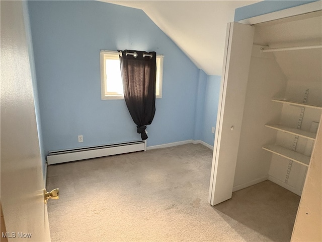 9513 Edison St NE, Alliance, OH 44601 - bonus room featuring a baseboard heating unit, lofted ceiling, and carpet flooring