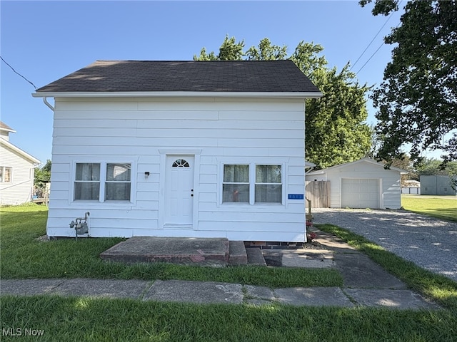 9513 Edison St NE, Alliance, OH 44601 - view of front of house featuring an outdoor structure, driveway, a garage, and a front lawn