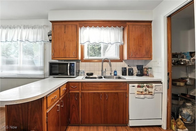 1932 Meister Rd, Lorain, OH 44053 - kitchen with white dishwasher, stainless steel microwave, light countertops, a peninsula, and backsplash