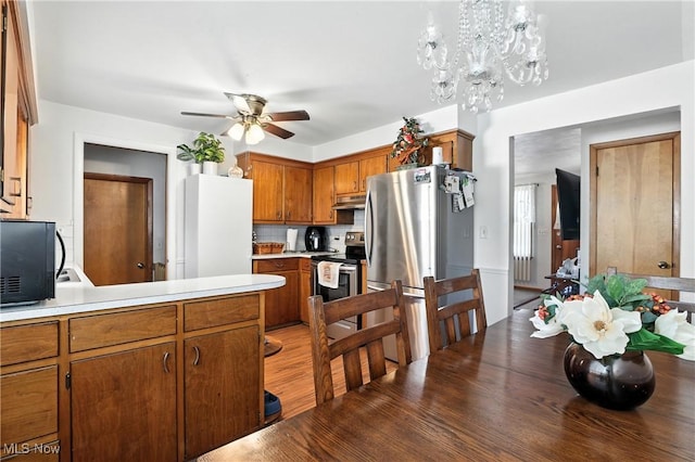 1932 Meister Rd, Lorain, OH 44053 - kitchen featuring appliances with stainless steel finishes, ceiling fan, light countertops, and brown cabinets