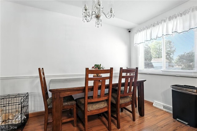 1932 Meister Rd, Lorain, OH 44053 - dining space featuring a chandelier, wood finished floors, and wainscoting