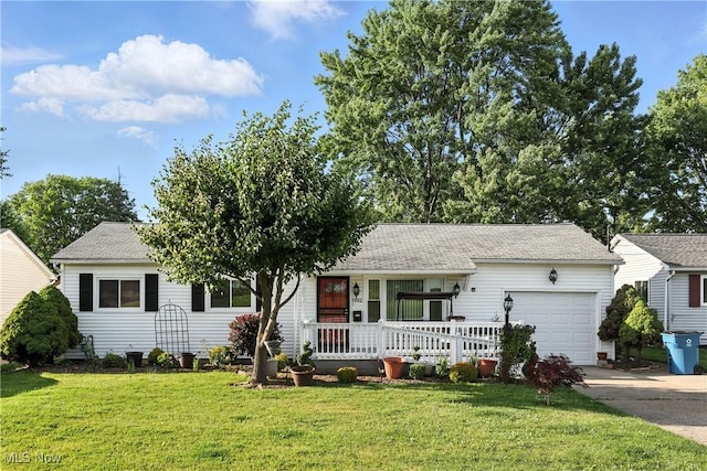 1932 Meister Rd, Lorain, OH 44053 - view of front facade with a garage, concrete driveway, covered porch, and a front yard