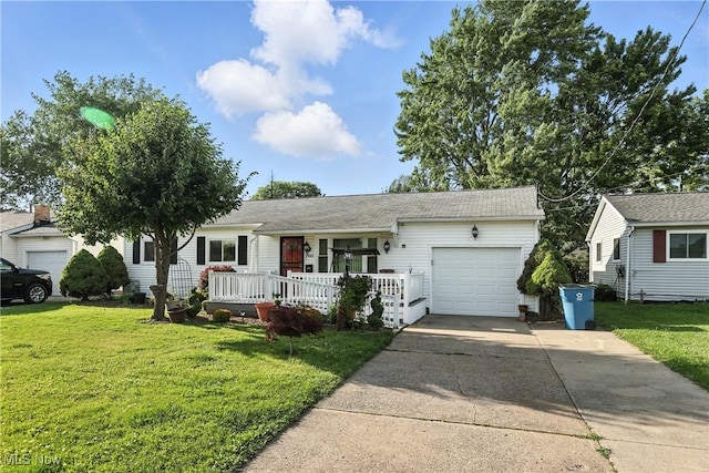 1932 Meister Rd, Lorain, OH 44053 - view of front of house with a garage, driveway, a front yard, and covered porch