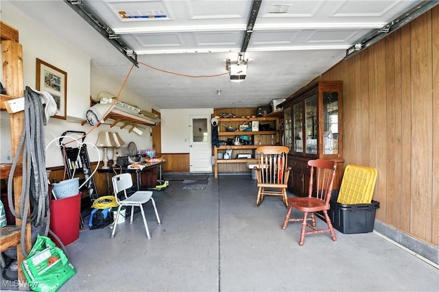 1932 Meister Rd, Lorain, OH 44053 - garage with wooden walls and a garage door opener