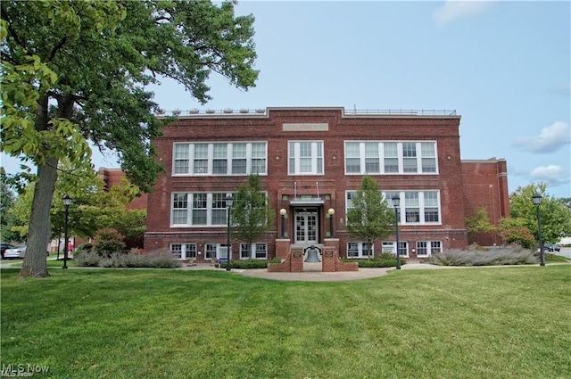 7482 Center St Unit 5, Mentor, OH 44060 - view of front facade with french doors, a front yard, and brick siding