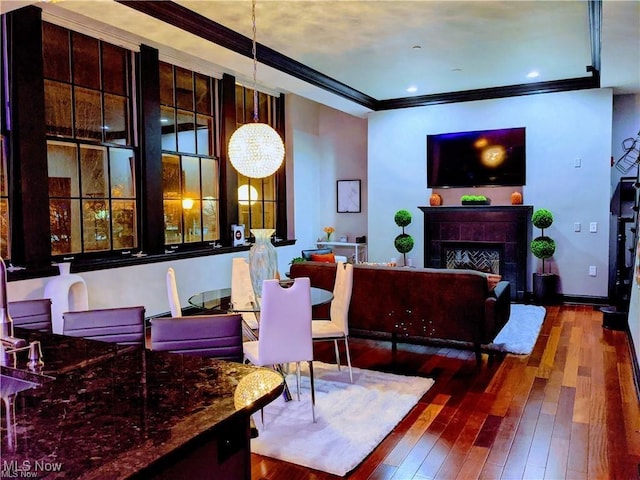 7482 Center St Unit 5, Mentor, OH 44060 - living area featuring hardwood / wood-style floors, crown molding, a fireplace, and a chandelier